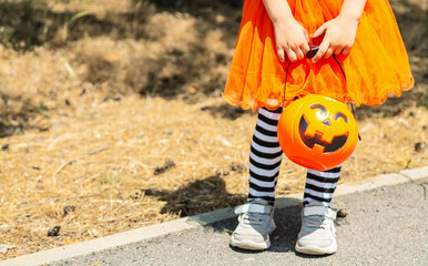 Kids trick or treat in Halloween costume. Children in colorful dress up with candy bucket on...