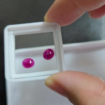 Pink ruby in white box moving to see star in ruby. Cabochon Burmese ruby