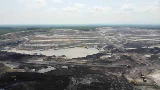 Aerial view panorama of open pit coal mining, dumper, extractive industry excavation, very large mine. Big Yellow Mining Truck