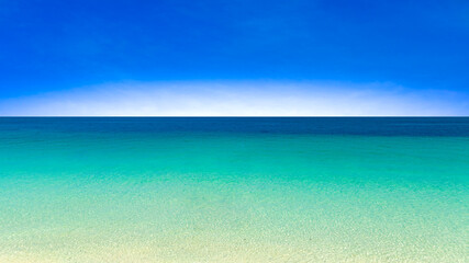 Nature of the beach and sea Summer with sunshine, sandy beaches, clear blue waters sparkling against the blue sky. On an island with good ecology and environment Background for summer vacation concept