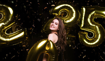 Happy gorgeous girl in stylish sexy party dress holding gold 2025 balloons, having fun at New...