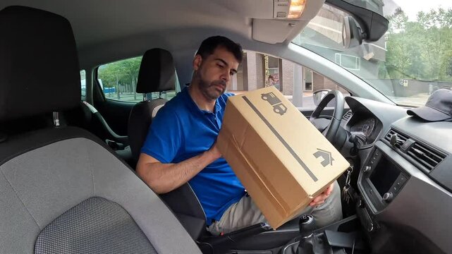 Side view of a mature delivery man writing notes inside a car in the city
