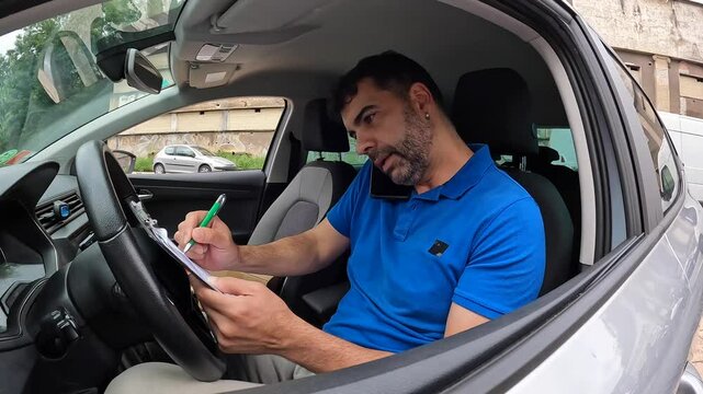 Courier talking to the mobile sitting on a van with packages to deliver