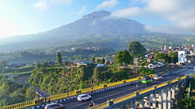AERIAL Beautiful indonesia rural landscape with view of SIgandul bridge and Sumbing Mountain on the background. Iconic bridge on Central Java, Indonesia.