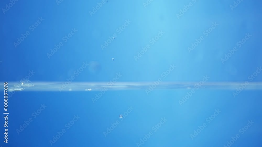 Poster close-up of water droplets splashing in slow motion, showing purity and transparency in a macro view
