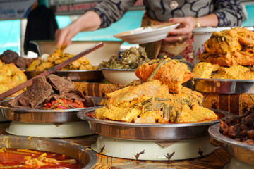 Variety of food in Indonesian market. Indonesian traditional food called Nasi Kapau with different type of menu