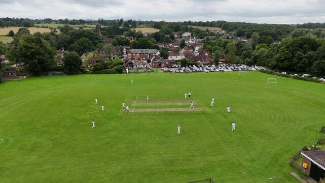 Cricket match Shere Surrey UK quaint English Village aerial drone