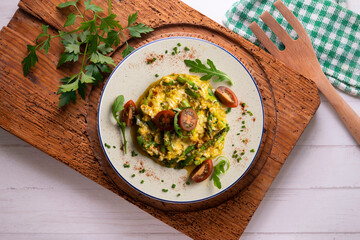 Scrambled organic chicken eggs with green asparagus and tomato. Top view table with  decoration.
