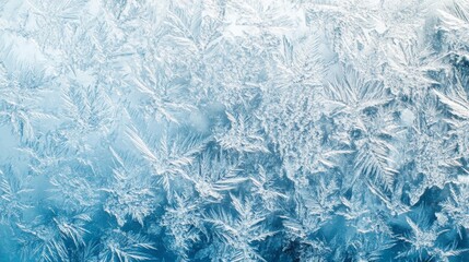 Fototapeta premium Frozen pattern on winter glass. Blue ice frost background, texture blue wallpaper. Crystals of snow on window surface. Screen overlay abstract design