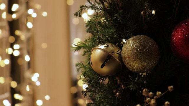 Christmas garland with gold jingle bells and sparkling fairy lights, winter background establisher