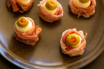 Spooky Halloween Eyeball Finger Food with Prosciutto, Mozzarella, and Green Olives - Keto Appetizer Close-Up