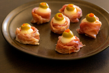 Spooky Halloween Eyeball Finger Food with Prosciutto, Mozzarella, and Green Olives - Keto Appetizer Close-Up
