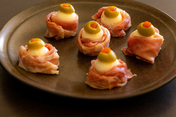 Spooky Halloween Eyeball Finger Food with Prosciutto, Mozzarella, and Green Olives - Keto Appetizer Close-Up