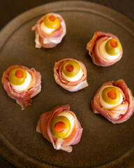Spooky Halloween Eyeball Finger Food with Prosciutto, Mozzarella, and Green Olives - Keto Appetizer Close-Up