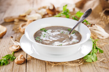 bowl of mushroom soup with cream and herbs