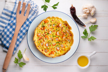 Individual quiche with vegetables and crab surimi. Top view table with decoration.