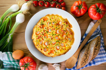 Individual quiche with vegetables and crab surimi. Top view table with decoration. © Leckerstudio