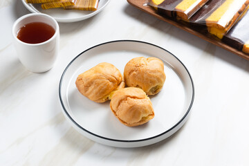 Choux pastry or cream puff. Profiterole. Kue sus. freshly baked. with vanilla cream filling. with copy space. perfect for recipe, article, catalogue, or any commercial purposes.