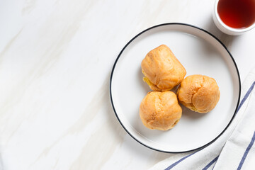 Choux pastry or cream puff. Profiterole. Kue sus. freshly baked. with vanilla cream filling. with copy space. perfect for recipe, article, catalogue, or any commercial purposes.