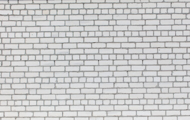 Fototapeta premium A white brick wall with a few blue bricks in it