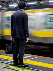 man waitng for train