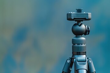 A sturdy tripod stands ready to capture breathtaking landscapes under soft morning light in a serene outdoor setting