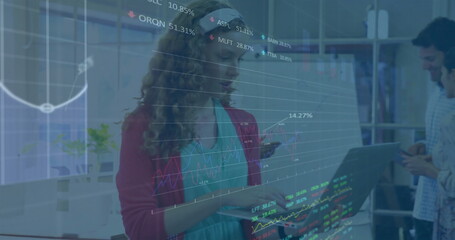 Image of financial data processing over diverse colleagues discussing work in office