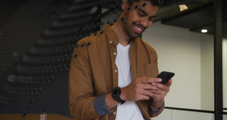 Image of financial data processing over biracial businessman using smartphone in office