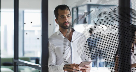 Image of globe and data processing over diverse business people in office