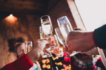 Cropped portrait of friendly peaceful family hands hold clink champagne gather celebrate new year xmas flat indoors