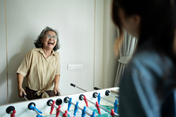 Mother and daughter playing games together at home
