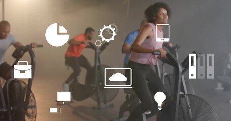 Image of business icons over diverse people using elliptical bikes on gym