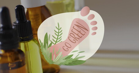Image of go green text, barefoot and plants logo, over natural oils on grey background