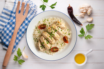 Baked chicken with thyme aroma on white rice. Top view table with decoration.