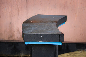 A sleek, modern curved bench made of concrete or stone, featuring a minimalist design. Perfect for architecture, urban spaces, or public seating projects