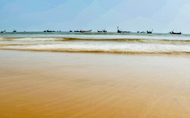 beach and sea with lot of boats and ships in the sea.