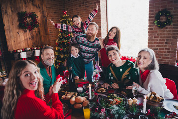 Photo of group family members sit festive table have fun gather celebrate christmas apartment indoors