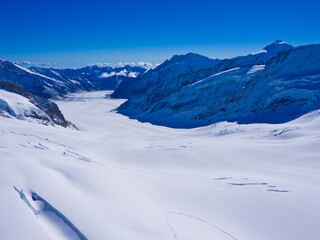 Alps Eiger and Jungfrau dramatic snowy mountain peaks panorama Switzerland.