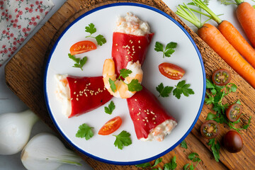 Red piquillo peppers stuffed with cod. Top view table with  decoration.