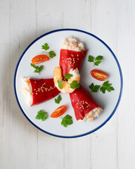Red piquillo peppers stuffed with cod. Top view table with  decoration.