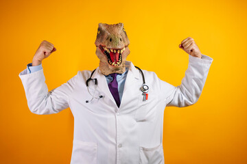 Doctor with dinosaur mask on a yellow background. © karrastock