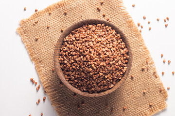 Buckwheat groats on wooden background. Healthy cereal concept