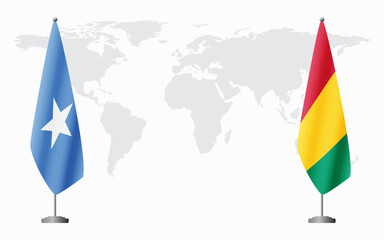 Somalia and Guinea flags for official meeting against background of world map.