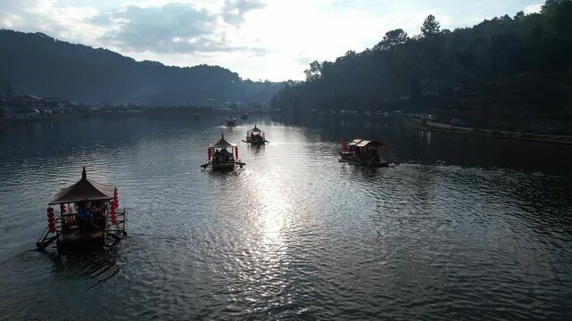 Take a local boat ride on a freshwater lake to enjoy the sunrise. The atmosphere is beautiful at Baan Rak Thai, Mae Hong Son Province,  Northern Thailand, Asia.