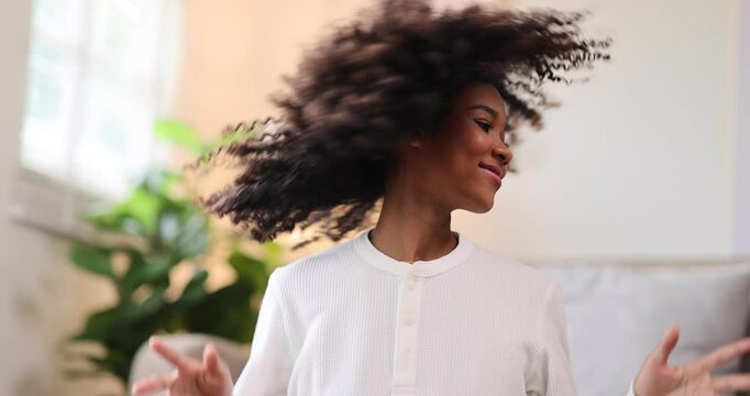 Hair care, portrait of african american girl smiling happy with her afro hair it home