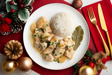 Garlic chicken with bay leaf aroma and white rice. Top view table with Christmas decoration.