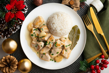 Garlic chicken with bay leaf aroma and white rice. Top view table with Christmas decoration.