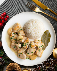 Garlic chicken with bay leaf aroma and white rice. Top view table with Christmas decoration.