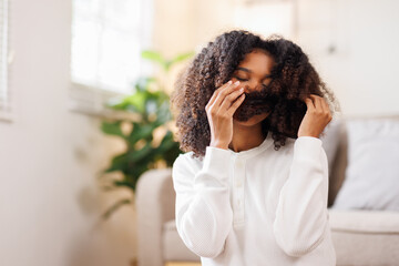 Hair care, portrait of african american girl smiling happy with her afro hair it home