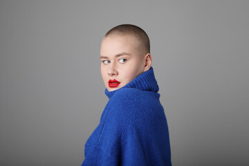 Beautiful young woman wearing casual blue jersey posing indoor. Mock-up.